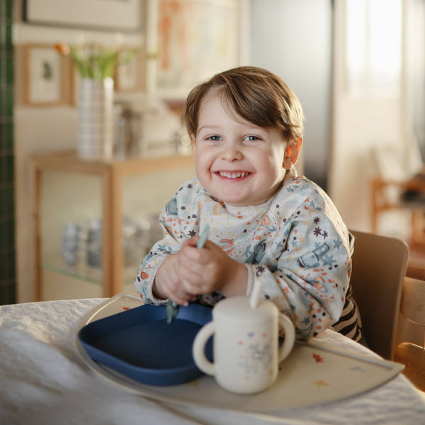 Silicone placemat for babies, angled view showcasing its vibrant design and easy-clean surface. Perfect for mealtime.