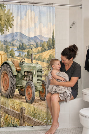 Mom holding her baby on the tub edge next to the Farm Tractor shower curtain