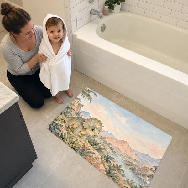 Mom and toddler in a hooded towel next to the Baby Triceratops Dinosaur bath mat
