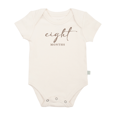 Taupe short sleeve bodysuit for baby, featuring an eight months milestone graphic.