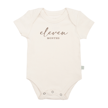 Taupe short sleeve bodysuit featuring eleven months milestone graphic for babies.