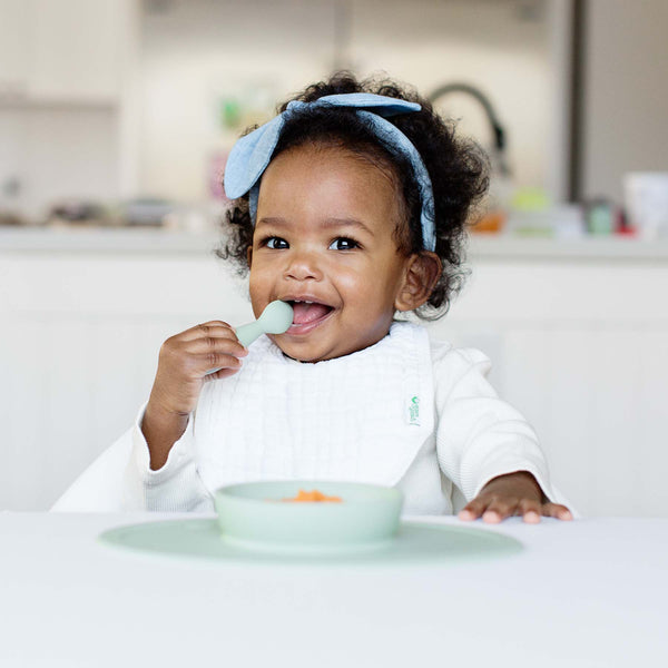 Baby-Led™ Tiny Spoons in a 30-degree angle, perfect for encouraging self-feeding in infants.