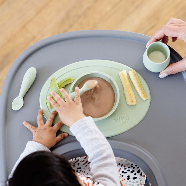 "First Foods Set for babies, featuring colorful utensils and bowls, angled view showcasing essential mealtime accessories."
