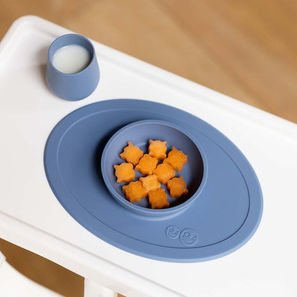 "First Foods Set for babies, featuring colorful utensils and bowls, perfect for introducing solid foods at mealtime."
