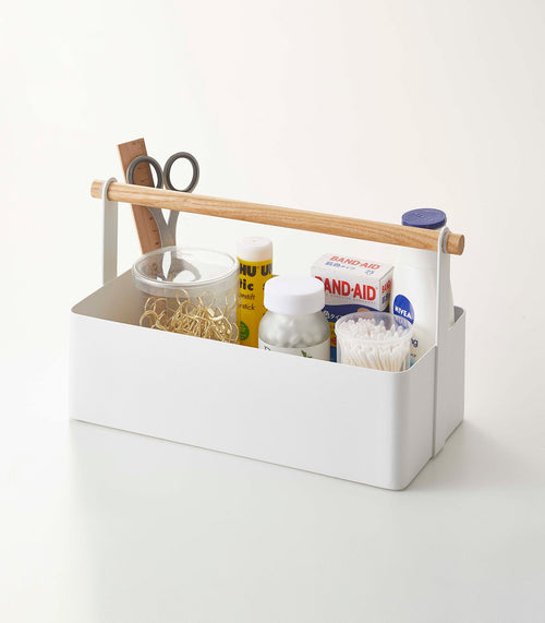 Large steel and wood storage caddy for organizing baby essentials on a desk.