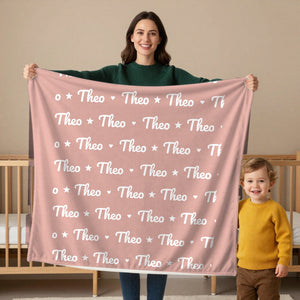 Name Pattern toddler sherpa blanket in blush, held by a mom