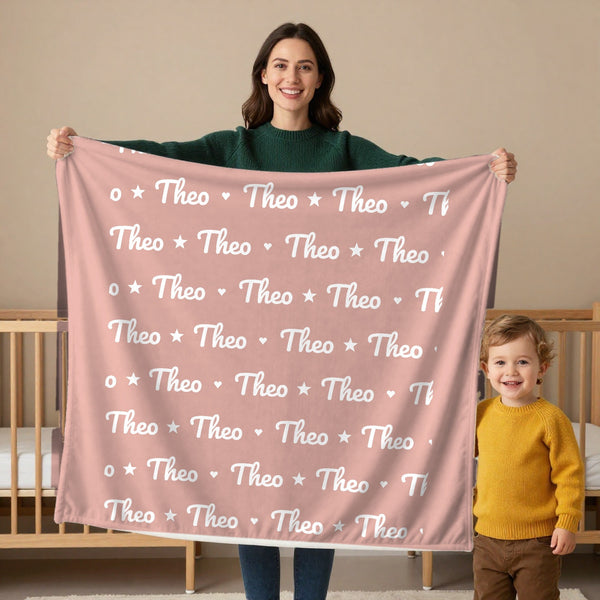 Name Pattern toddler sherpa blanket in blush, held by a mom