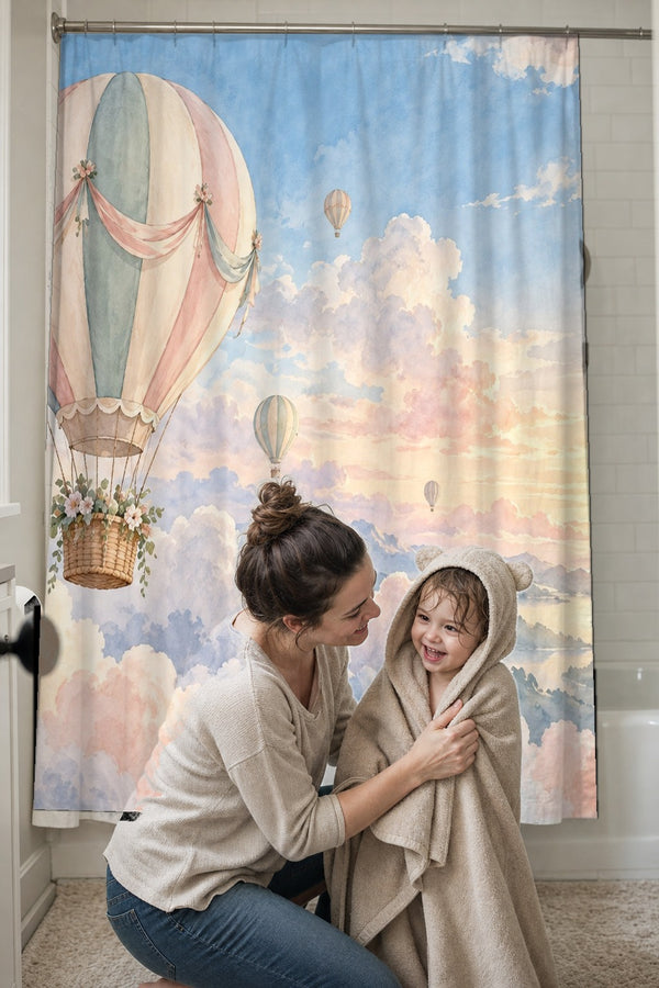 Mom drying her toddler in a hooded towel in front of the Dreamy Clouds Hot Air Balloon shower curtain