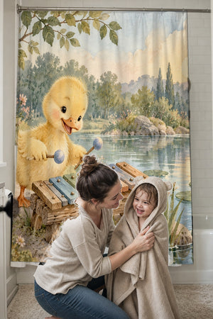 Mom drying her toddler in a hooded towel in front of the Duckling Xylophone shower curtain
