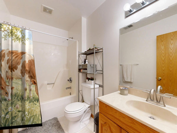 Cow and Calf Farm shower curtain on a tub shower combo in an American family bathroom