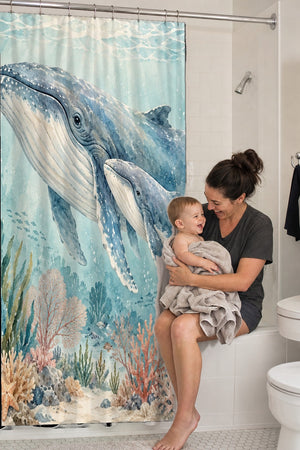 Mom holding her baby on the tub edge next to the Whale Family Ocean shower curtain
