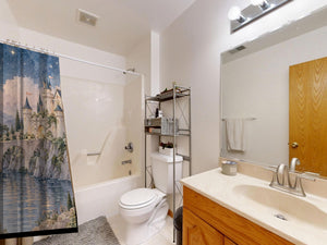 Moonlit Castle Fairy Tale shower curtain on a tub shower combo in an American family bathroom