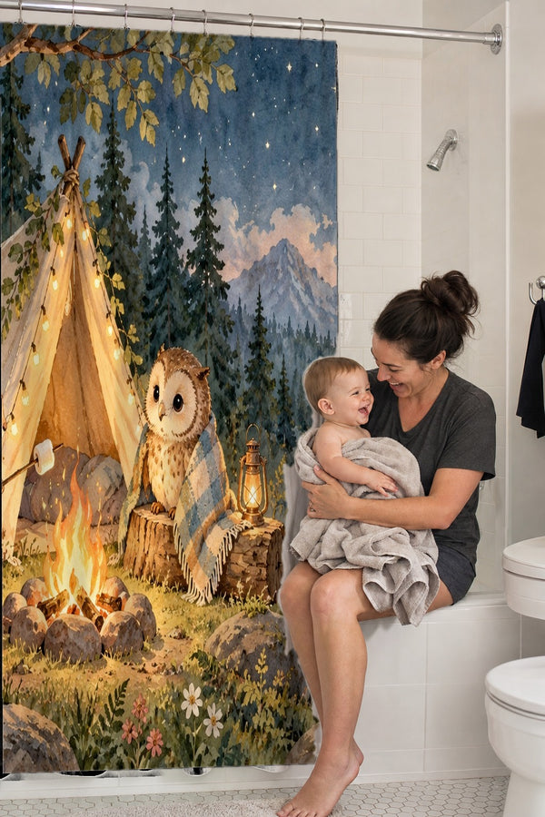 Mom holding her baby on the tub edge next to the Moonlit Forest Camp Camping shower curtain