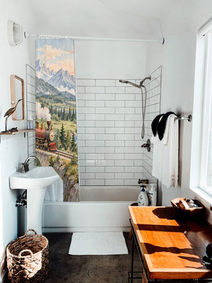 Panoramic Train Journey shower curtain hanging on the rod over a white bathtub