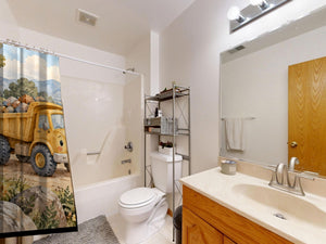Dump Truck Road shower curtain on a tub shower combo in an American family bathroom