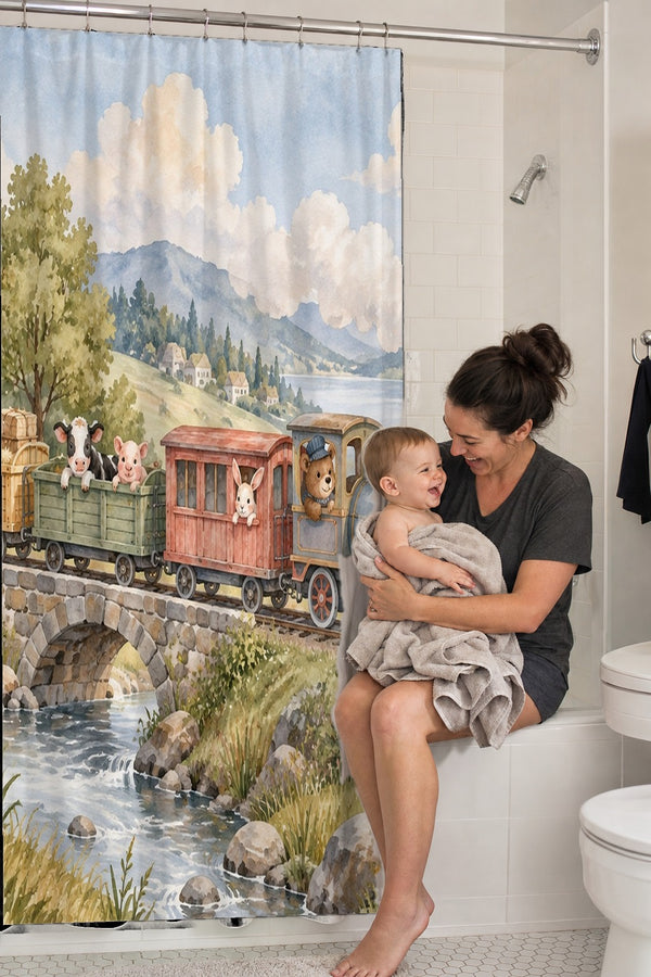 Mom holding her baby on the tub edge next to the Countryside Train shower curtain