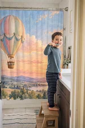 Child brushing teeth in a family bathroom with the Sunset Flight Hot Air Balloon shower curtain