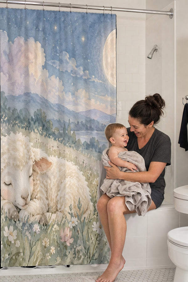 Mom holding her baby on the tub edge next to the Meadow Lamb shower curtain