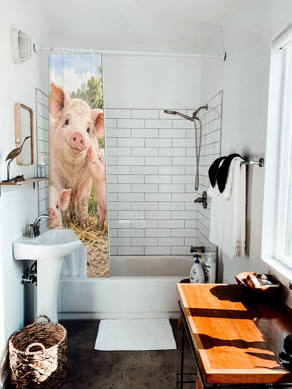 Piglet Family Farm shower curtain hanging on the rod over a white bathtub