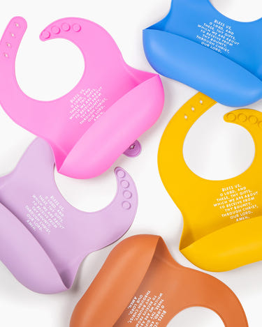 "Meal Blessing Silicone Bib in vibrant colors, perfect for mess-free feeding and easy cleanup for babies."