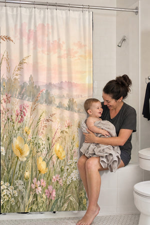 Mom holding her baby on the tub edge next to the Golden Sunset Wildflowers shower curtain