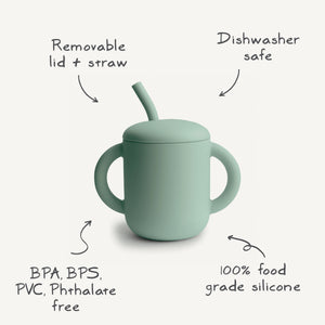 Silicone training cup with straw, angled view, perfect for toddlers learning to drink independently.
