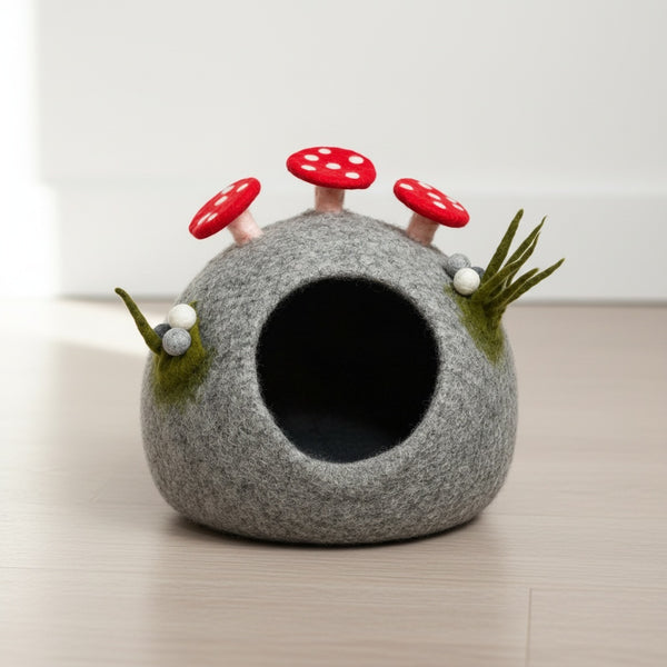 Close up view of the felt mushroom cat cave showing its wool texture and red spotted mushroom details