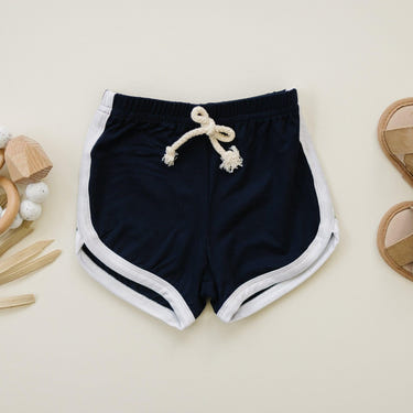 Navy blue bamboo track shorts for babies, soft and comfortable, perfect for playtime and casual outings.