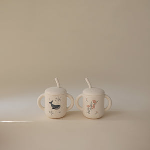 Silicone training cup with straw at angle 54, perfect for toddlers learning to drink independently.