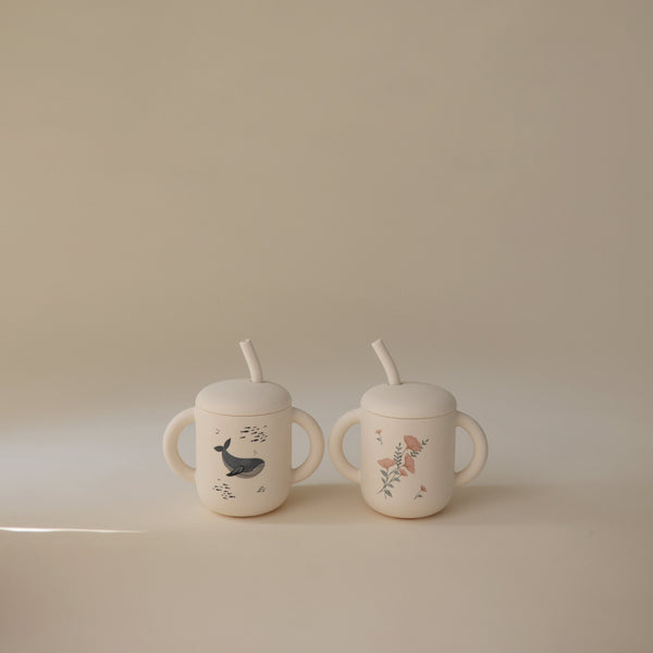 Silicone training cup with straw at angle 54, perfect for toddlers learning to drink independently.