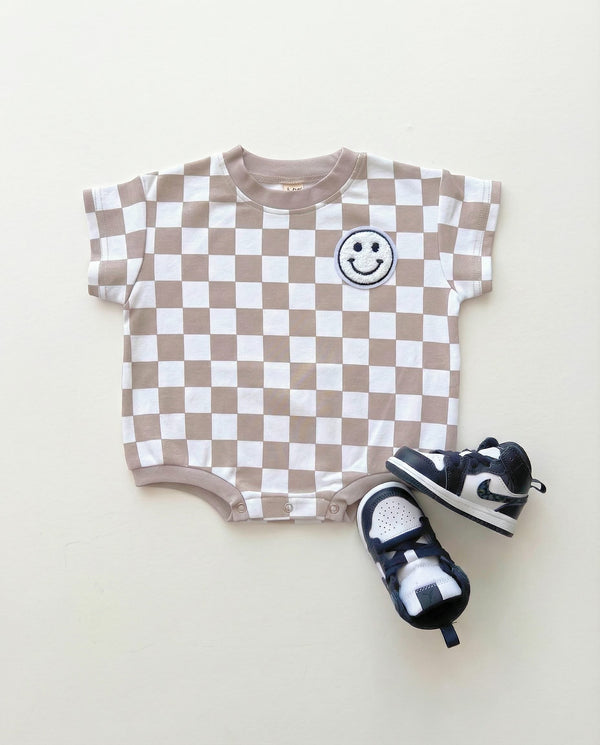 Short Sleeve Bubble Romper in Checkered Smiley Latte for babies, showcasing a playful design at angle 5.