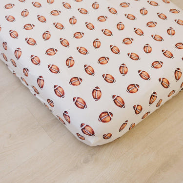 Football print bamboo crib sheet for stylish and comfortable baby bedding.
