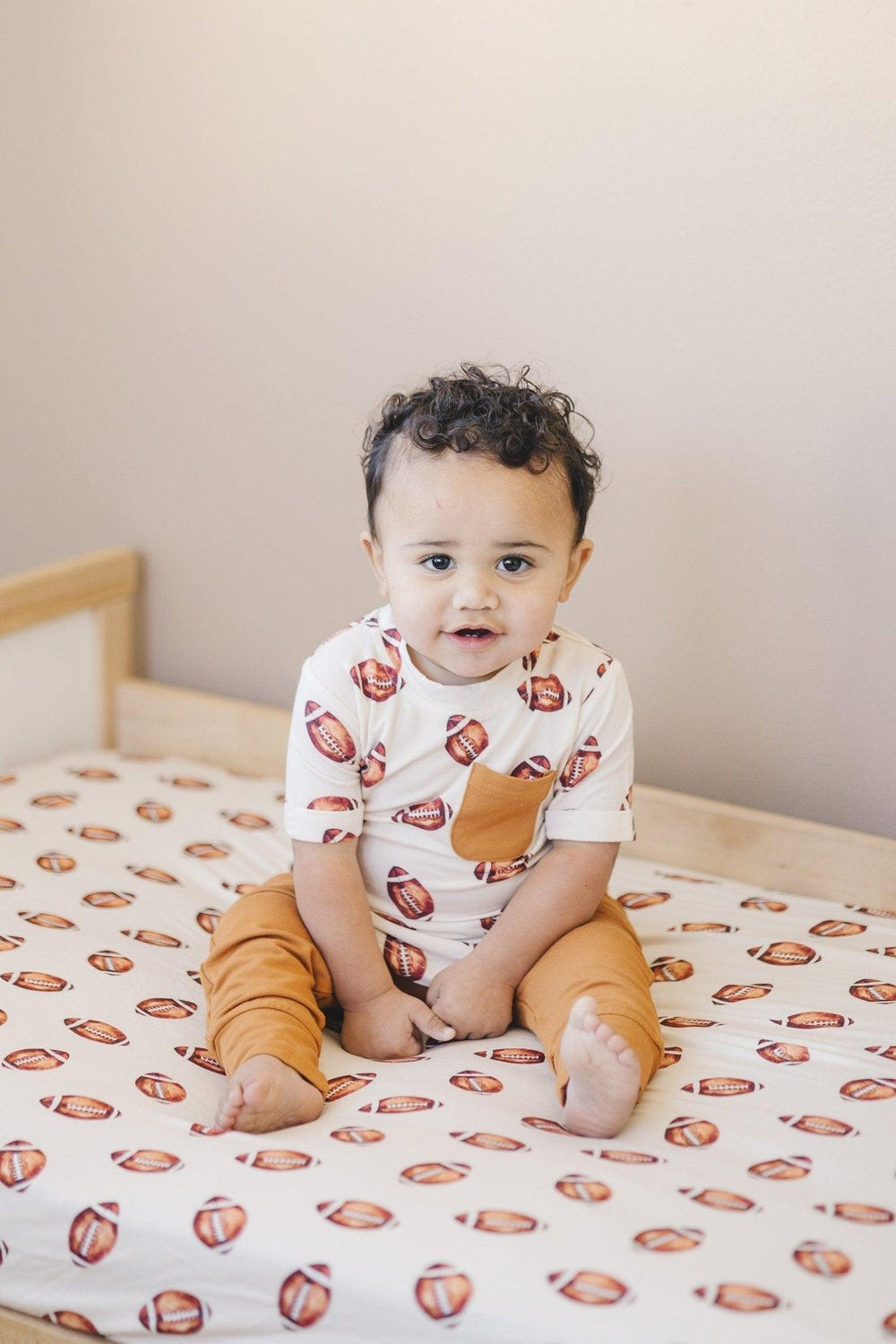 Football print bamboo crib sheet for stylish and comfortable baby bedding.