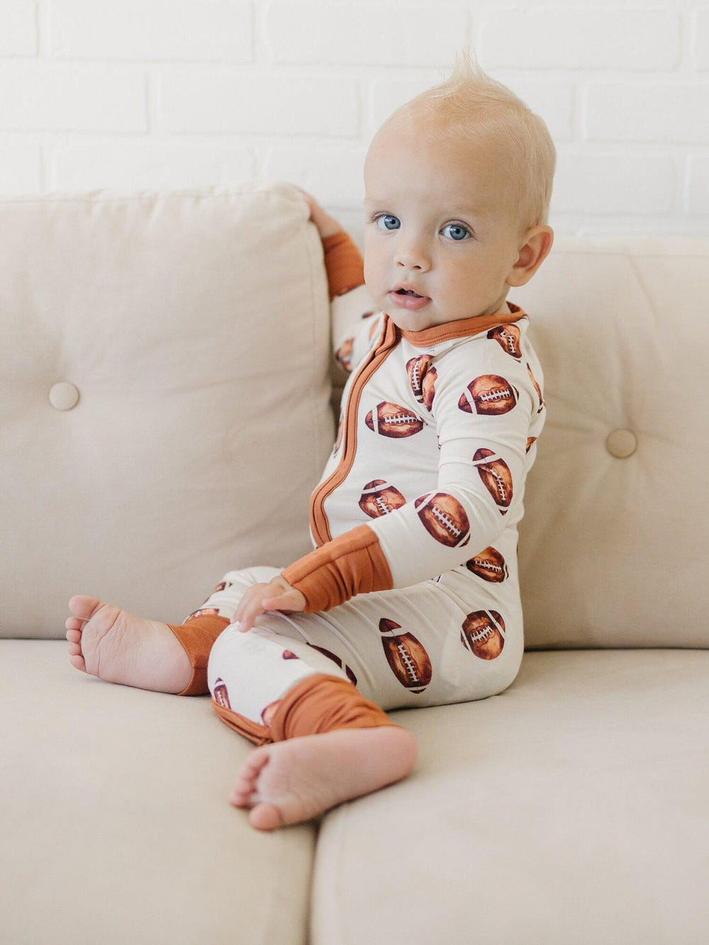 Football print bamboo zippy romper for babies, perfect for comfort and style in rompers and overalls.