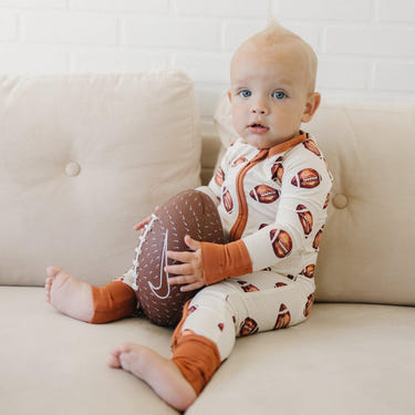 Football print bamboo zippy romper for babies, perfect for comfort and style in rompers and overalls.