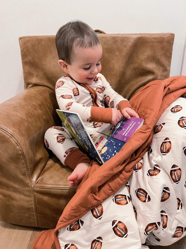 Football print quilted bamboo blanket for babies, 1.0 Tog, perfect for swaddling and cozy comfort.