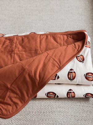 Football print quilted bamboo blanket for babies, 1.0 Tog, perfect for swaddling and cozy comfort.