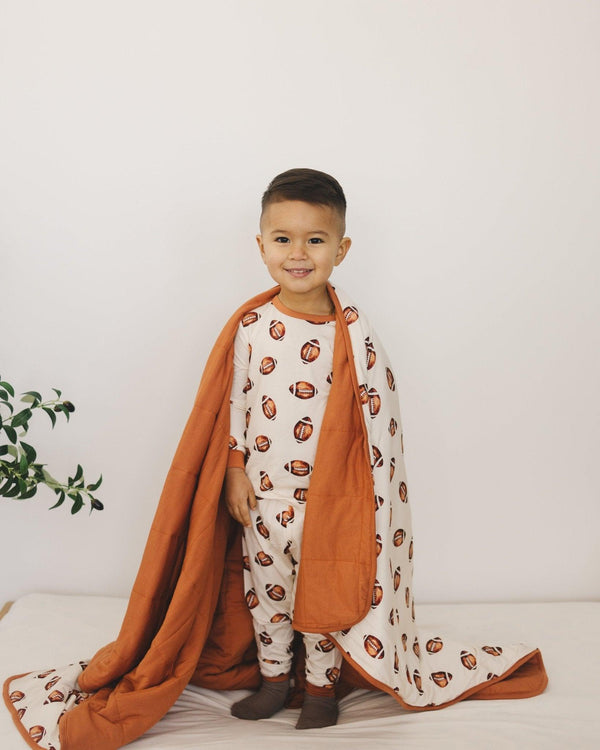 Football print quilted bamboo blanket for babies, 1.0 Tog, cozy swaddle for comfort and warmth.