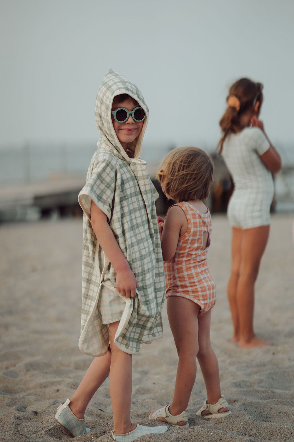Organic cotton bathing towel poncho in fern plaid for babies, perfect for post-bath comfort and warmth.