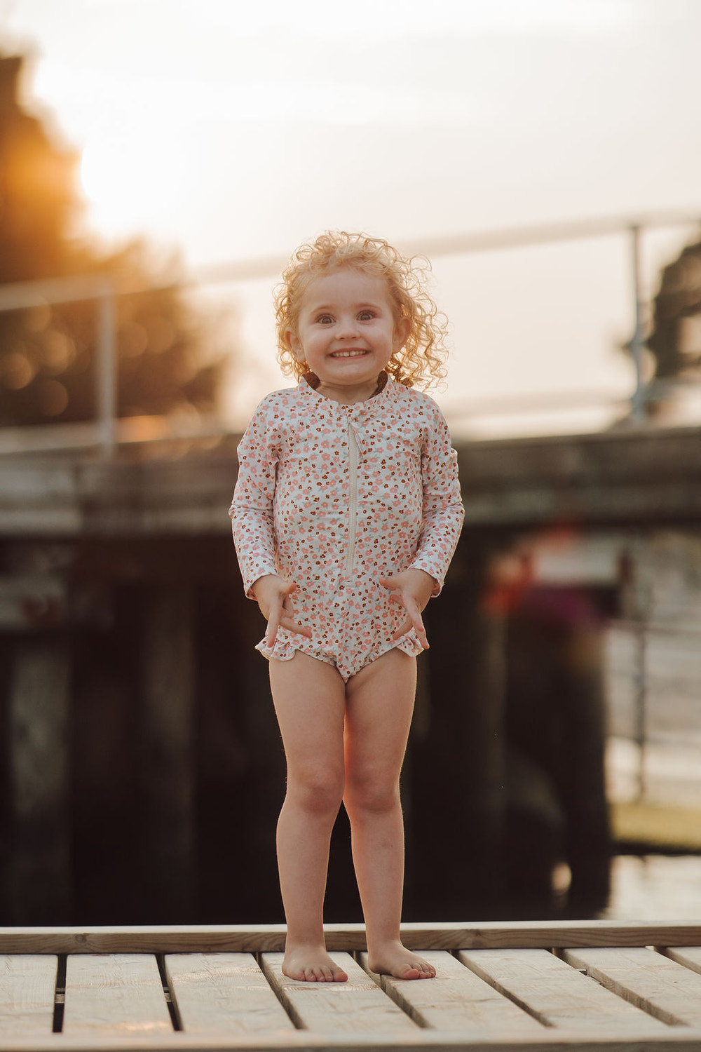 Long Sleeve Rashguard Ruffle Swimsuit for babies in Sunset Meadow print, UPF protection, made from recycled materials.