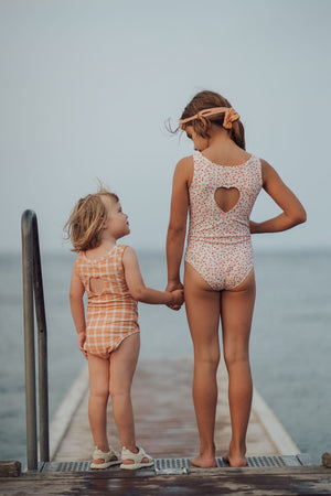 Sweetheart 1 Piece Swimsuit in Buckwheat Plaid, UPF protected, eco-friendly, angle view. Perfect for baby swimwear.