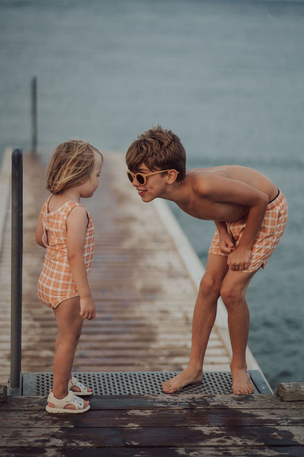 Baby swim trunks in Buckwheat Plaid, UPF protection, made from recycled materials, angle view.