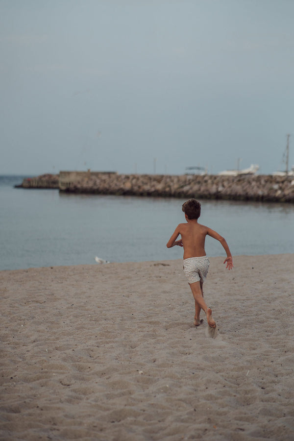 Baby swim trunks in Scandi floral design, UPF protected and made from recycled materials, angle view 13.