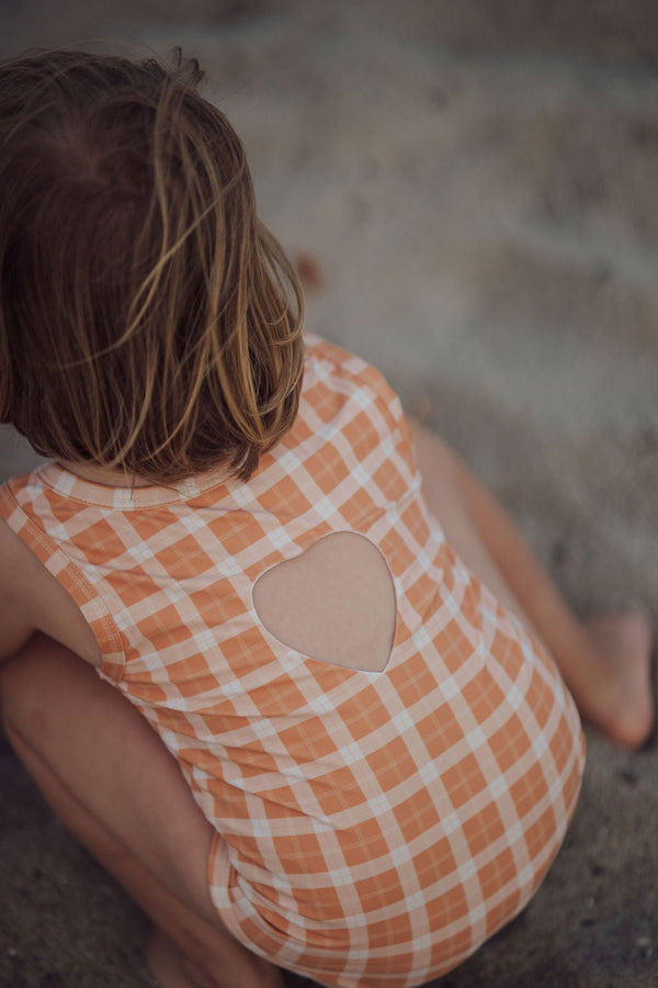 Sweetheart 1 Piece Swimsuit in Buckwheat Plaid, UPF protected and made from recycled materials, angle view.