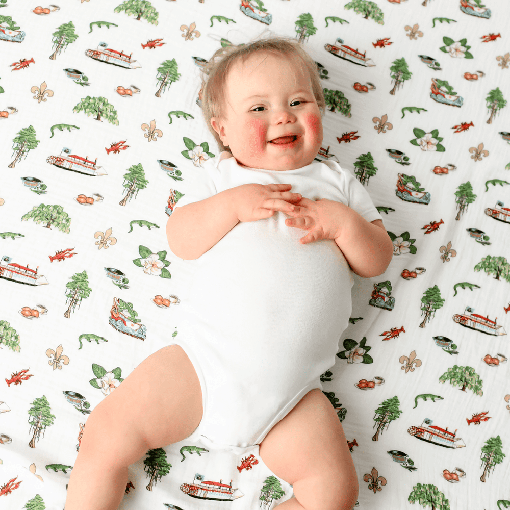 Louisiana Baby Muslin Swaddle Blanket and Burp Cloth/Bib Combo gift set for infants, perfect for swaddling and feeding.