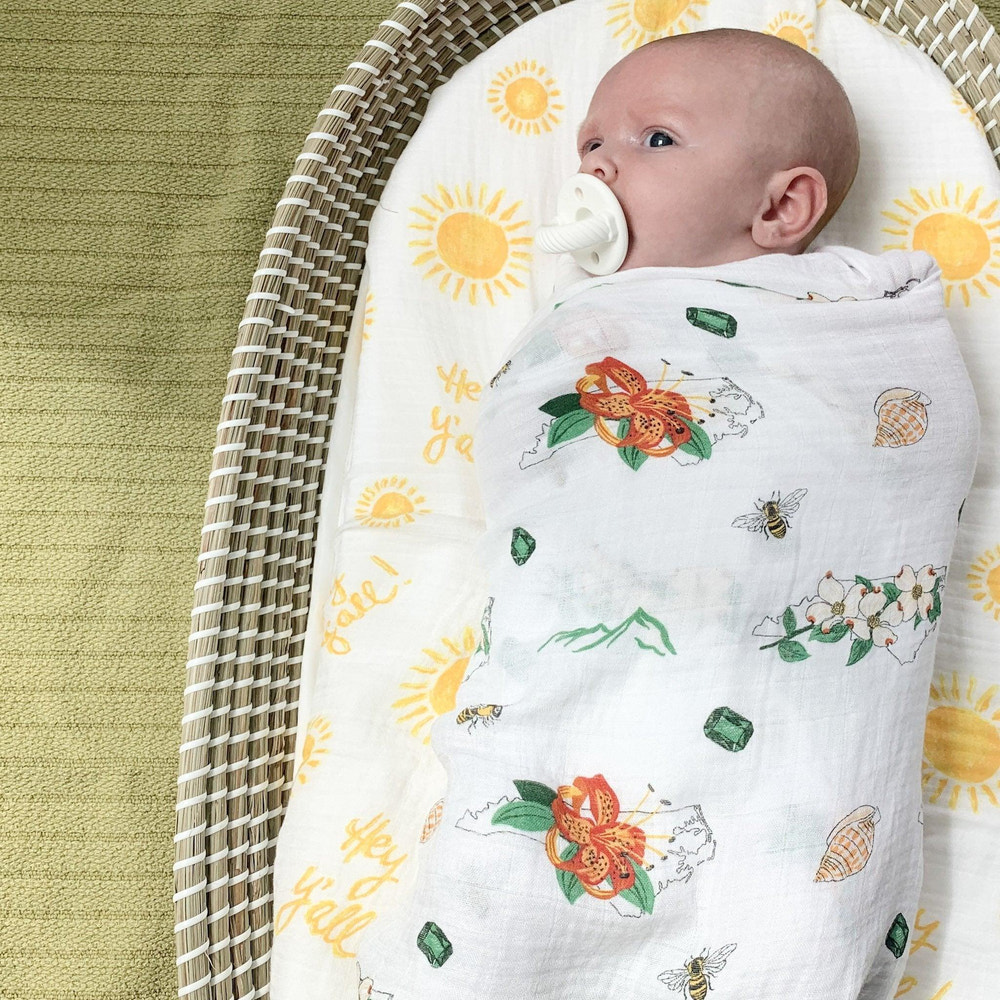 North Carolina baby muslin swaddle blanket and floral burp cloth/bib combo gift set. Perfect for newborns.