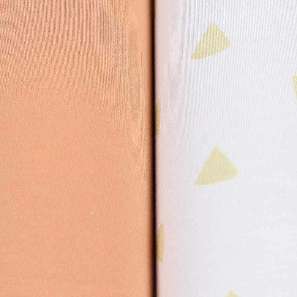 Tan triangle and terra cotta 2-pack swaddle blankets for babies, soft and stylish for comfortable swaddling.