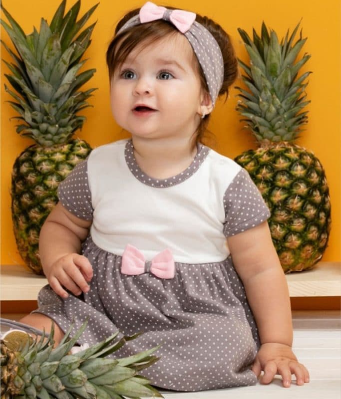 Gray baby dress with pink bow tie, perfect for special occasions and everyday wear.