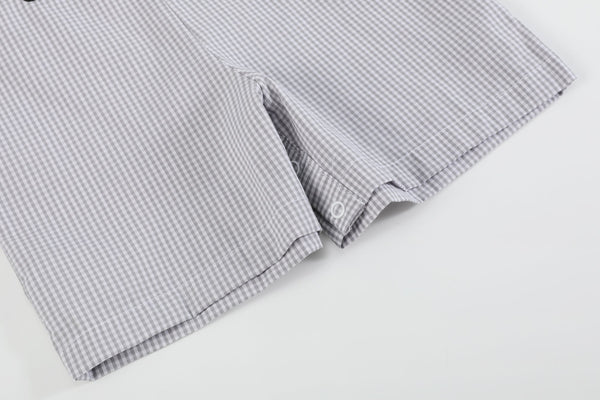Grey gingham puppies in truck shortalls for babies, stylish and playful outfit angle view.