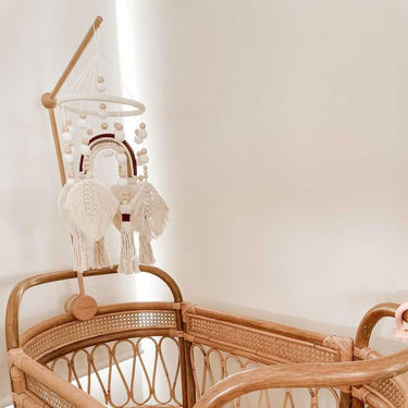 Handmade Boho nursery mobile featuring a macrame rainbow design for stylish baby room décor.